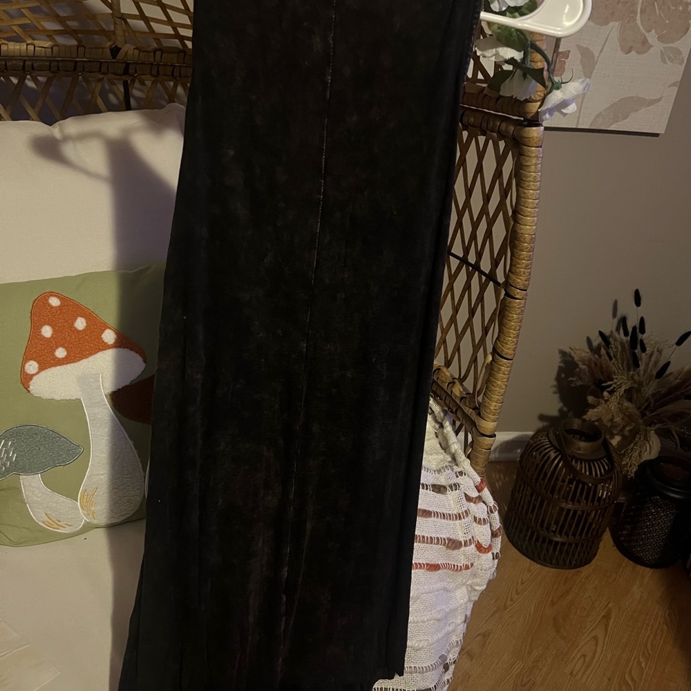Edgy sleeveless dress, features a soft, texture and asymmetrical draped hem.